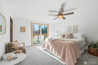 Primary bedroom with direct deck access, offering a peaceful indoor-outdoor connection.