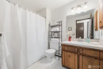 Full bath conveniently serving the main level, enhanced by updated lighting and new flooring.