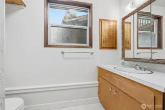 Convenient downstairs 3/4 bath serving the lower-level living areas.