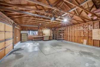 Interior of detached garage/shop offering generous space for storage, parking, or projects.