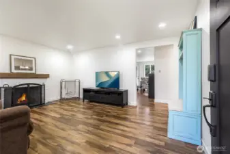 Enter to the living room with wood burning fireplace.