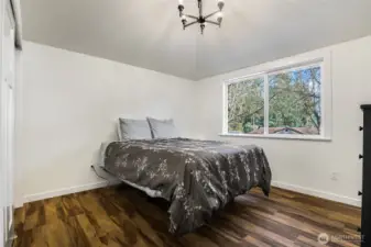 Primary bedroom with vaulted ceilings.