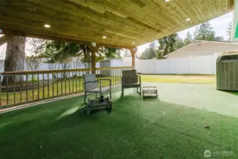Large covered back deck withs cedar lined ceiling