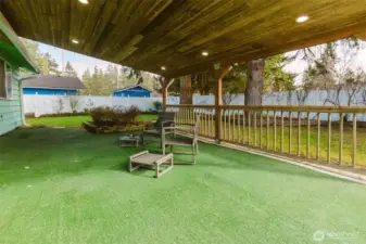Large covered back deck withs cedar lined ceiling