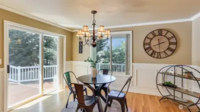 This dining space is bathed in natural light with walls of windows and slider leading to the massive wrap-around deck overlooking your private back yard.