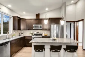 The generously sized kitchen is fully equipped with modern stainless steel appliances, all of which are included with the home.