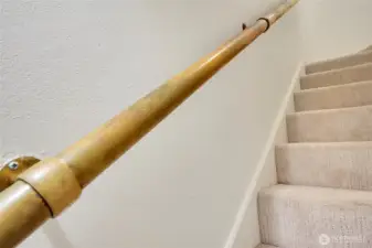 Brass railing leads you up stairs.