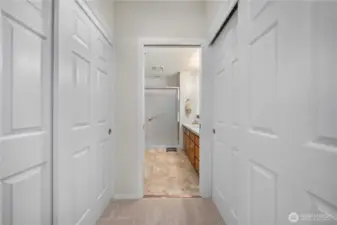 Walk through to primary bath. 2 of 3 primary bedroom closets with custom features.