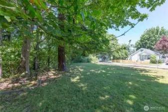 Side yard looking toward detached garage area