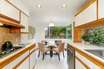 The spacious kitchen features an eating nook and direct access to the patio.
