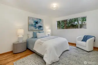 Primary bedroom overlooks back yard.