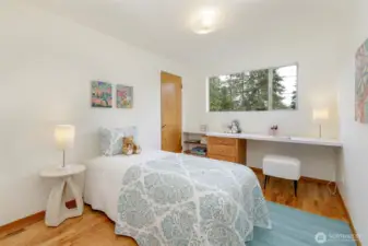 Main level second bedroom includes a built-in desk.