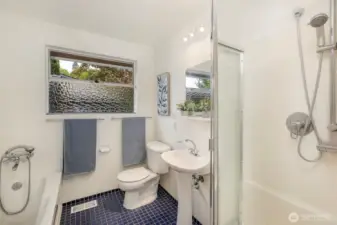 Main level bathroom features a separate bath and shower.