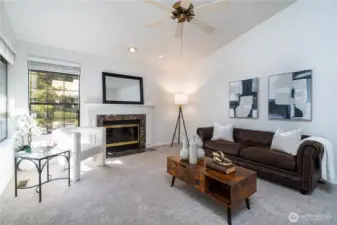 Vaulted ceilings in living room with new carpet and paint
