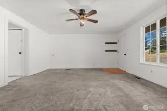 Enjoy a large, open living room that flows effortlessly into the kitchen, highlighted by windows that frame views of the street and driveway.