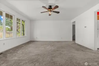 Enjoy a large, open living room that flows effortlessly into the kitchen, highlighted by windows that frame views of the street and driveway.