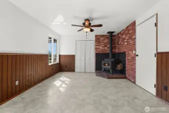 The dining area offers a cozy atmosphere with a wood-burning fireplace, providing the perfect spot for meals and gatherings.