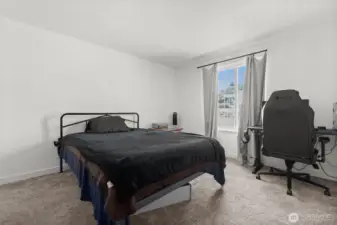 Retreat to the spacious primary bedroom — the largest in the home — with direct access just across the hall to the main-floor bath for everyday convenience.