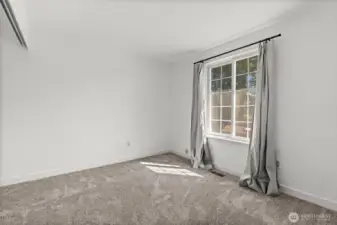 A second bedroom on the main floor offers easy access to the main-floor bathroom and enjoys views of the backyard.