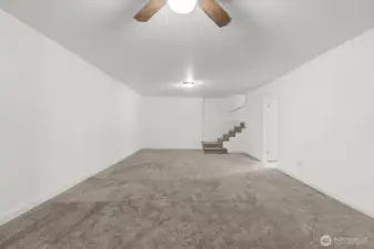 Headed downstairs? Discover the ultimate gathering space — an expansive bonus room highlighted by a giant wood-burning fireplace insert, with plenty of room for a big-screen TV, couches, game table, or even a home gym.