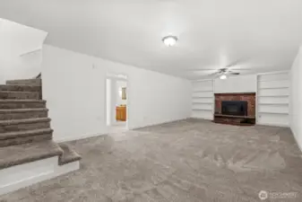 Headed downstairs? Discover the ultimate gathering space — an expansive bonus room highlighted by a giant wood-burning fireplace insert, with plenty of room for a big-screen TV, couches, game table, or even a home gym.