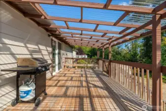 Step onto the covered backyard deck with sweeping views of the half-acre yard — the perfect place to entertain guests rain or shine, and a true extension of the home’s living space.