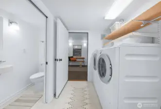Laundry room with Miele washer and dryer. To the left is the 3/4 bathroom for guests. Straight-away is another bonus room perfect for storage or a Peleton!