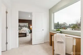 Large windows for light in the primary bath with a nook for makeup vanity or linen storage cabinet.  Actual home is under construction and finishes, colors, and materials may vary. See site agent for details.