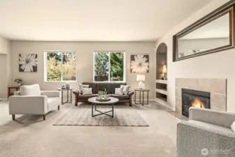 The tiled gas fireplace is flanked by arched, recessed built-in shelving, with plug-ins for specialty lighting.