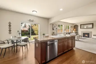 The kitchen opens to the manicured backyard through an extra-large sliding glass door—ideal for outdoor dining.