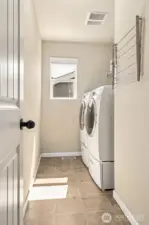 Upstairs laundry room is perfect -- where the bedrooms are! Includes shelving & drying rack.