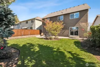 Nicely arranged plantings and the perfect level lawn for play!