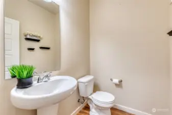 Nicely tucked around the corner from the kitchen is the main floor powder room.