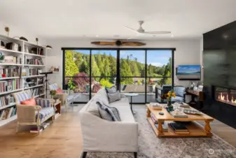 This home features stunning views through full-panel sliders that open seamlessly to the expansive deck, merging indoor and outdoor living.