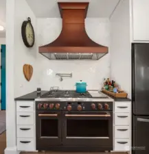 Enjoy the 48inch Cafe range with custom copper hood. This is a kitchen you'll be proud to showcase.