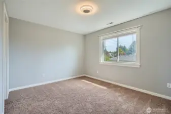 Spacious bedroom number 4 on upper level featuring fresh paint, creating a clean and inviting atmosphere perfect for relaxation and personalization.
