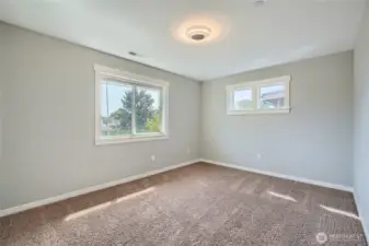 Spacious bedroom number 3 on upper level featuring fresh paint, creating a clean and inviting atmosphere perfect for relaxation and personalization.