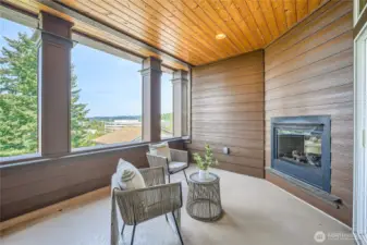 Experience year-round outdoor living on the covered deck featuring a stunning dual-sided fireplace—perfect for cozy evenings or stylish entertaining. Soak in panoramic city views from this elevated retreat, seamlessly blending comfort and sophistication. Whether you're enjoying a morning coffee or hosting under the stars, this space offers the ultimate in ambiance, privacy, and breathtaking scenery.