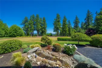 Tranquil water feature overlooking the back yard, stamped concrete patio, plenty of gardening beds with seasonal flowers & room to personalize.