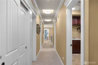 Hallway leading to other bedrooms, bathrooms, bonus room & theater room.  Utility room on right.