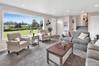 This shot highlights the staircase leading up to the upstairs bedrooms and bathrooms, while the door on the right provides access to the basement.