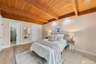 Another view of the main-level bedroom highlighting convenient bathroom access and a spacious walk-in closet, along with durable, easy-care luxury vinyl plank flooring.