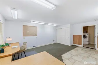 The space also includes a convenient storage closet, ideal for keeping office supplies, workout gear, or hobby materials neatly tucked away.