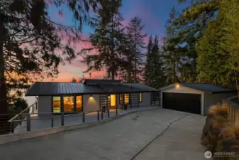 Detached garage with metal roof and custom metal door for durability and character.