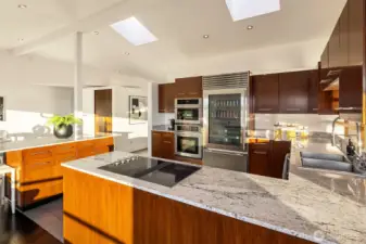 Architecturally designed ceilings and custom kitchen cabinetry maximize space and create a modern look