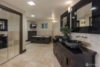 Spacious primary bathroom with heated floors & dual sinks creating a spa like retreat at home