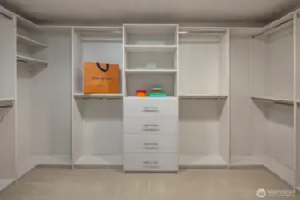 Primary suite features custom closets designed to maxize organization and storage.