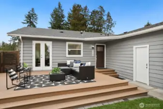 As you enter through the gate, you see the large Trex deck on the front of the house.