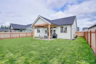 Large, fully fenced back yard with covered patio.