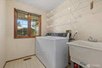 Laundry room with convenient utility sink.
